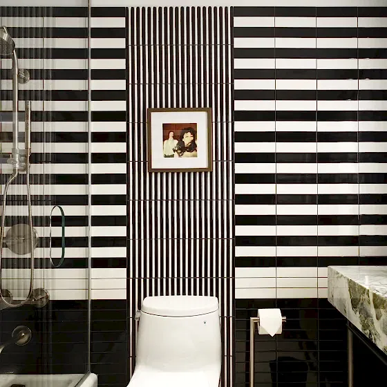 a bathroom with a distinctive black and white striped design at the Park Lane New York hotel.
