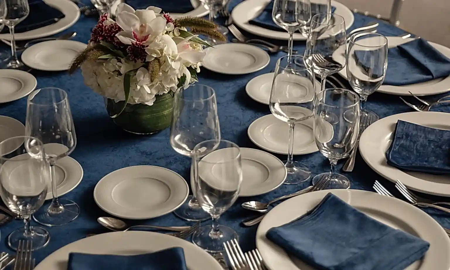 formal dining table setting, for a wedding or event, featuring a blue velvet tablecloth at the Empire Room