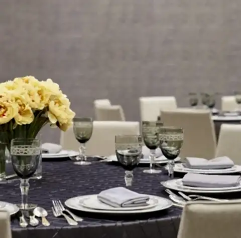 A table set with china, cutlery and glasses for an event.