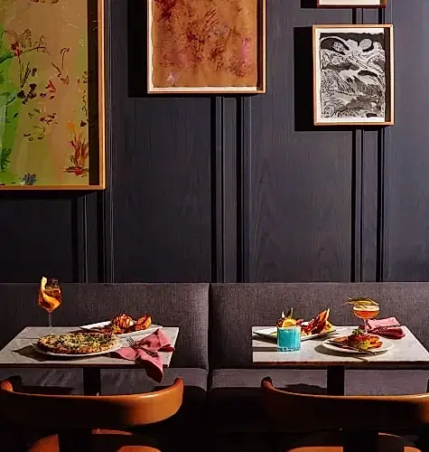 Two tables with assorted dishes on them.