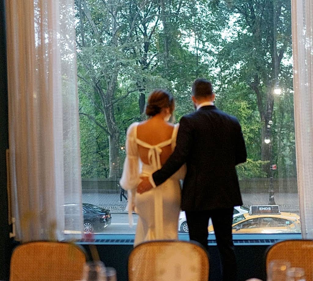 bride and groom looking outside at their wedding in NYC at Park Lane hotel