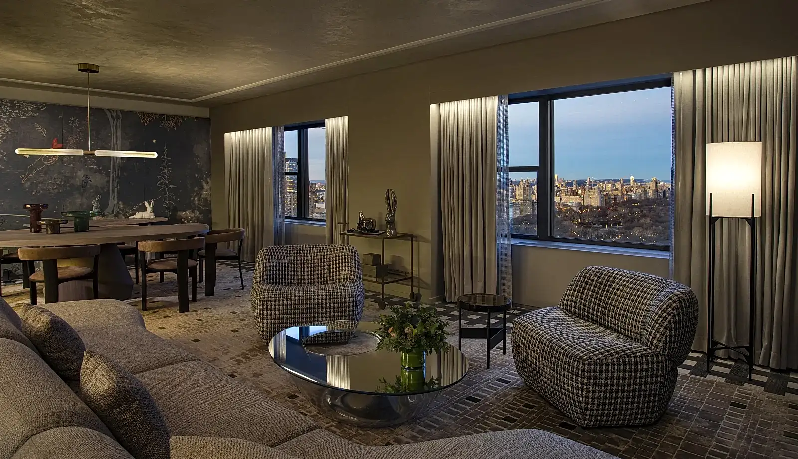 A spacious seating area and dining area in the Belvedere Suite overlooking Central Park at Park Lane New York.