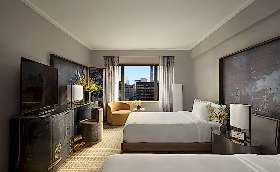 A two queen room with desk and seating area overlooking the city at Park Lane New York.