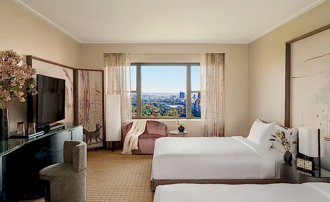 A two queen room with desk and seating area overlooking Central Park at Park Lane New York.